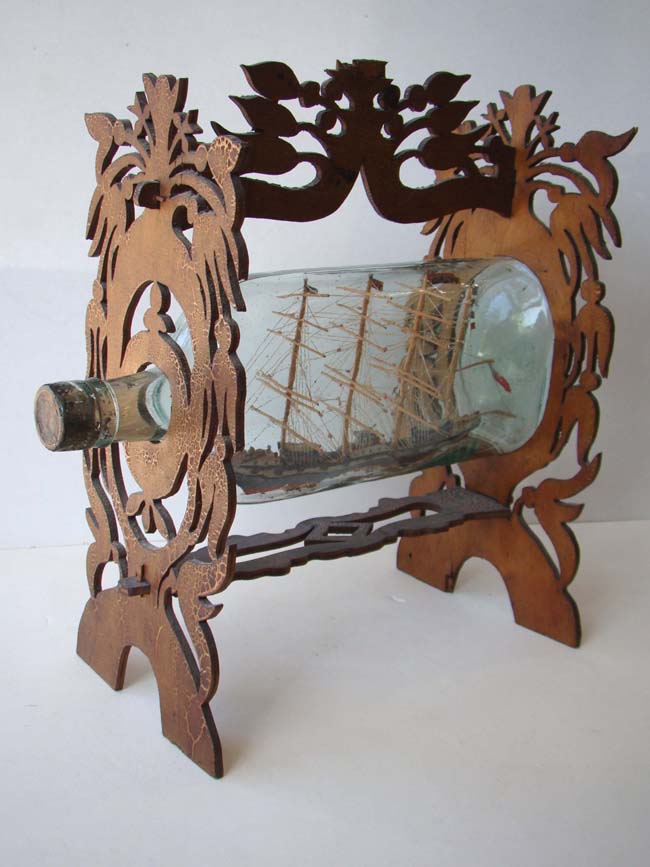 A fine 19th century Ship in a Bottle mounted in a carved fretwork stand circa 1880-1900